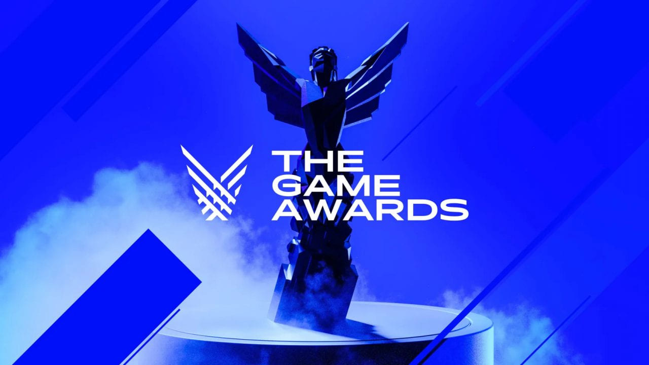 Logo di The Game Awards 2023 con statua su sfondo blu fumoso.